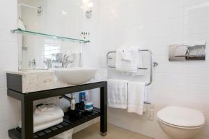 a bathroom with a sink and a toilet at The Reef Resort in Taupo