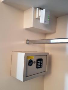 a microwave hanging on a wall in a room at Maison Authier in Périgueux