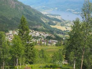 a view of a village in a valley with trees at Voss, Øvre Tråstølen in Skulestadmo