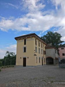 a large yellow building with a gate in front of it at B&B Molinetto in Piacenza