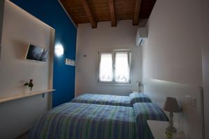 Łóżko lub łóżka w pokoju w obiekcie Il Rifugio Del Tempo