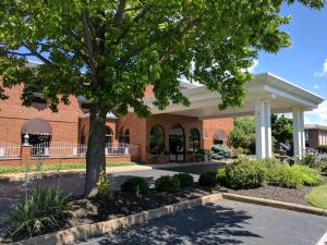 a brick building with a tree in front of it at South Shore Inn in Sandusky