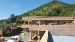 a house with a car parked in front of it at Bubez Guesthouse in Barberton