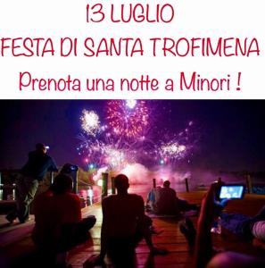 a group of people sitting around watching fireworks at La conchiglia in Minori