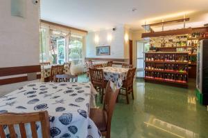 a dining room with tables and chairs and a shelf with wine bottles at Villa Brigantina in Sunny Beach