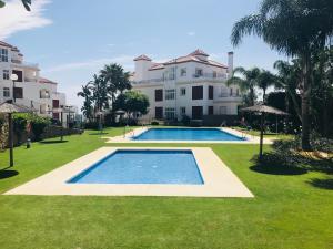 a swimming pool in front of a large building at Princesa Kristina in Manilva