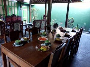 a wooden table with food on top of it at Pendopo Kayuwanan Syariah Near Terminal Giwangan in Yogyakarta