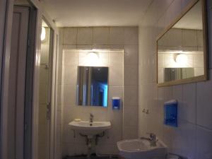 a bathroom with a sink and a mirror at Kretan Hostel in Bucharest +34 photos