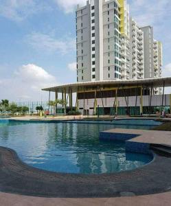 a building with a pool of water in front of a building at Studio Homestay@JB in Johor Bahru