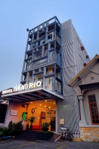 a building with a sign on the front of it at Hotel Dafam Rio in Bandung