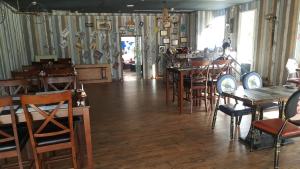 a restaurant with wooden tables and chairs in a room at Platinum Hotel Apartments in Abu Dhabi