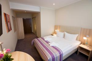 una habitación de hotel con una cama grande y una mesa en Hotel Siebenschläfer en Alsdorf