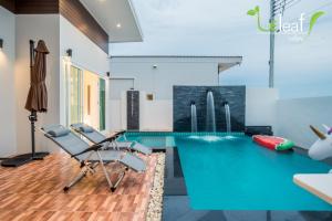 a swimming pool with two chairs and a table at Le Leaf Valley Hua Hin 29 in Hua Hin