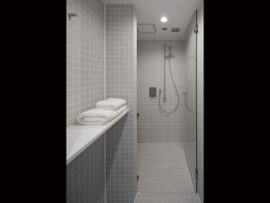 a bathroom with a shower and a sink at 9h nine hours Akasaka sleep lab in Tokyo