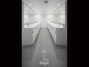a black and white photo of a bathroom with sinks and mirrors at nine hours Akasaka sleep lab in Tokyo