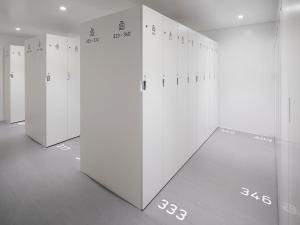 a row of white lockers in a room at 9h nine hours Akasaka sleep lab in Tokyo