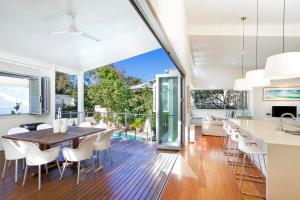 an open kitchen and dining room with a table and chairs at 20 Adams Street, Sunshine Beach in Noosa Heads