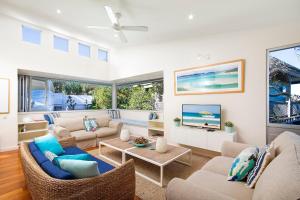 a living room with a couch and a tv at 20 Adams Street, Sunshine Beach in Noosa Heads