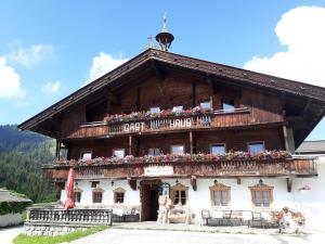 a large wooden house with a balcony at Traditionsgasthof Sollererwirt in Thierbach