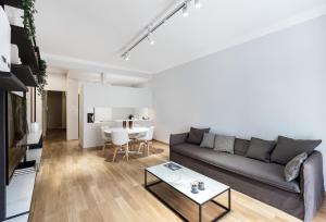 a living room with a couch and a table at Kolonaki Square Apartment in Athens +18 photos
