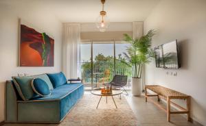 a living room with a blue couch and a table at The Ottoman House Boutique By Domus in Beer Sheva