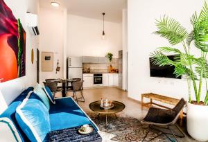 a living room with a couch and a table at The Ottoman House Boutique By Domus in Beer Sheva