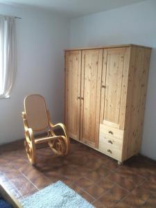 a chair sitting next to a cabinet in a room at DG Rechts 108A 2 Zimmer Apartment Dachgeschoss in Holzminden