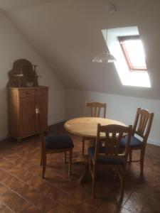 a dining room with a table and four chairs at DG Rechts 108A 2 Zimmer Apartment Dachgeschoss in Holzminden