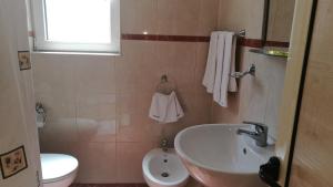 a bathroom with a sink and a toilet at Family Hotel Mimosa in Tsarevo