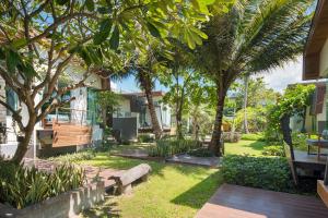 a park with a bench and trees and grass at Idyllic Concept Resort in Ko Lipe