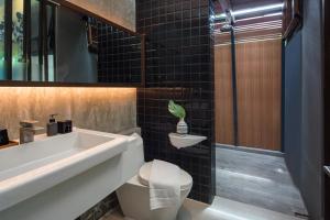 a bathroom with a sink and a toilet at Idyllic Concept Resort in Ko Lipe