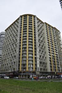 a large building with people walking in front of it at Hotel Orbi Plaza in Batumi