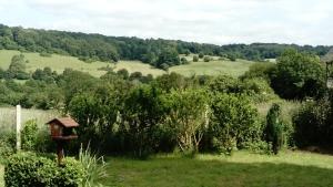 a bird house in the middle of a field at La petite maison normande in Ticheville +1 photo