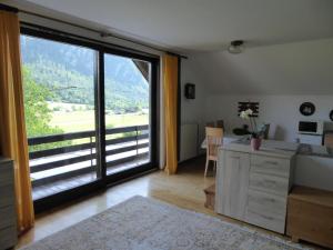 a living room with a large sliding glass door at Apartment Tina in Bohinj