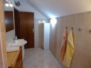 a bathroom with a sink and a white refrigerator at Apartment Tina in Bohinj +38 photos