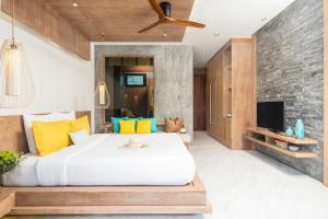 a bedroom with a large bed and a tv at Idyllic Concept Resort in Ko Lipe