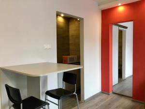 a dining room with a table and two chairs at Emilia - У центрі міста, Приватне паркування в закритому дворі in Mukacheve