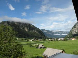 a village in a valley with mountains in the background at Apartment Tina in Bohinj