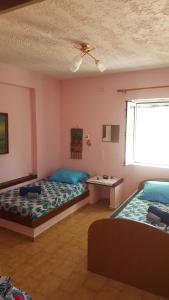 Habitación con 2 camas y mesa. en Villa Spiros, en Hersonissos