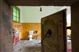 an open door to a bathroom with a toilet at The Kandy Samadhicentre in Kandy