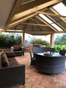 a patio with a table and chairs under an umbrella at Dampier House Mullaloo-Perth in Perth