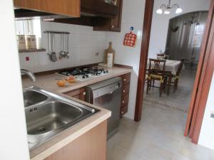 a kitchen with a sink and a stove top oven at Casa Dario in Melissano