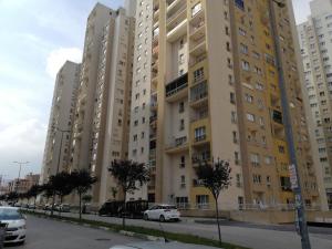 an apartment building with cars parked in front of it at شقق مفروشة غرفتين وصالون 110 in Bursa