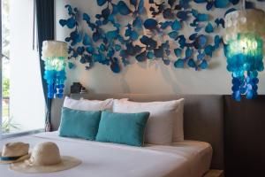 a bedroom with a bed with blue and white decorations at Idyllic Concept Resort in Ko Lipe