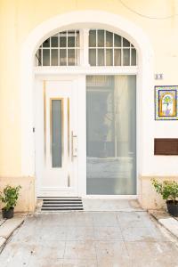 a white door of a building with a window at Guest house libertà in Balestrate