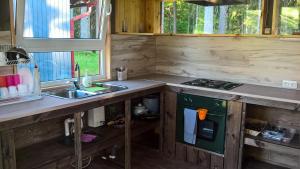 a kitchen with a sink and a stove top oven at Kempings Ozolkalns in Cēsis