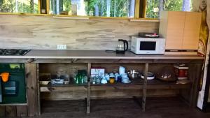 a table with a microwave on top of it at Kempings Ozolkalns in Cēsis