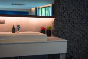 a bathroom with a white sink and a mirror at Idyllic Concept Resort in Ko Lipe