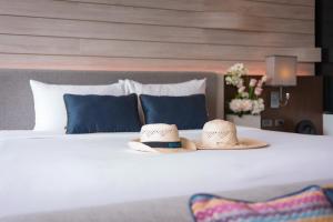 two hats sitting on top of a bed at Idyllic Concept Resort in Ko Lipe