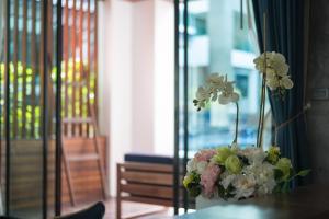 a vase filled with flowers sitting on a table at Idyllic Concept Resort in Ko Lipe
